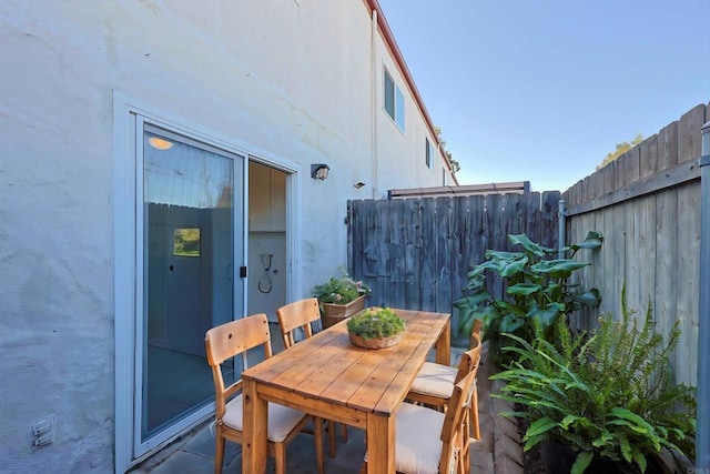 view of patio with fence and outdoor dining area