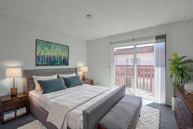 bedroom featuring dark carpet and access to exterior