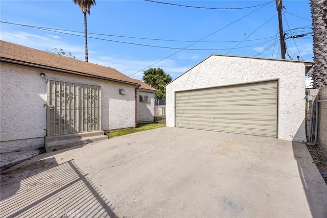 detached garage featuring fence