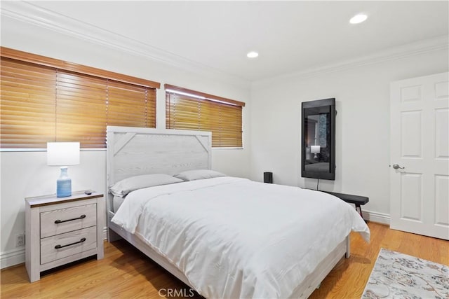 bedroom featuring recessed lighting, baseboards, crown molding, and light wood finished floors