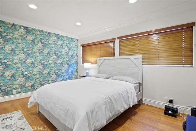 bedroom with crown molding, recessed lighting, wood finished floors, baseboards, and wallpapered walls