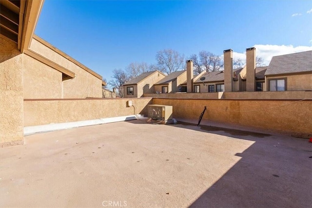 view of patio with a residential view and fence