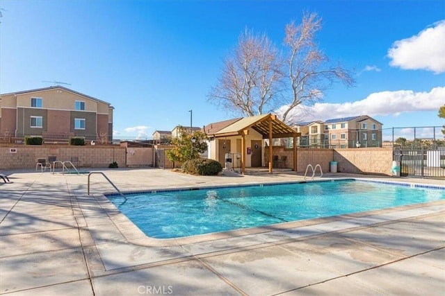 pool featuring a patio area and fence