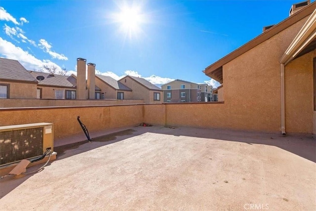 view of patio with a residential view and fence