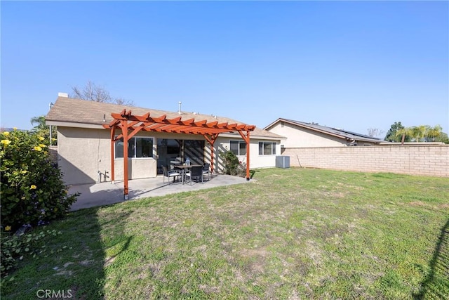 back of property featuring stucco siding, a yard, a fenced backyard, and a pergola