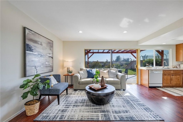 living room with light wood finished floors, recessed lighting, and baseboards