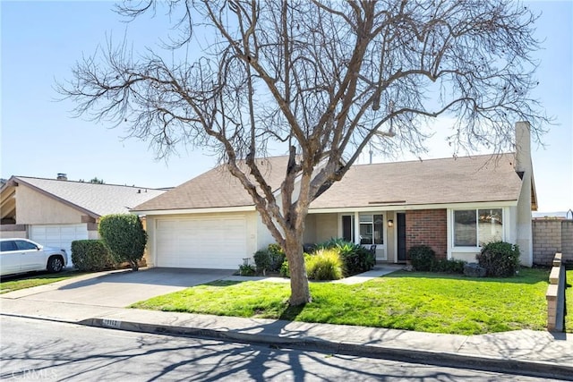 single story home featuring a garage, brick siding, driveway, stucco siding, and a front yard