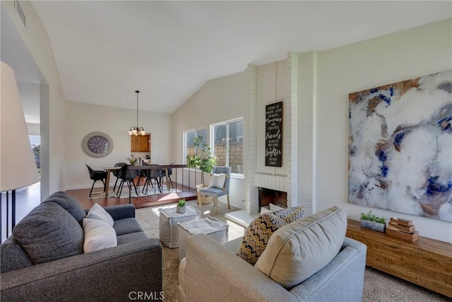 living area with lofted ceiling, a fireplace, visible vents, and a notable chandelier