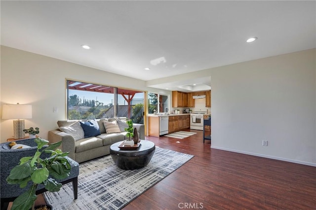 living area with recessed lighting, dark wood finished floors, and baseboards