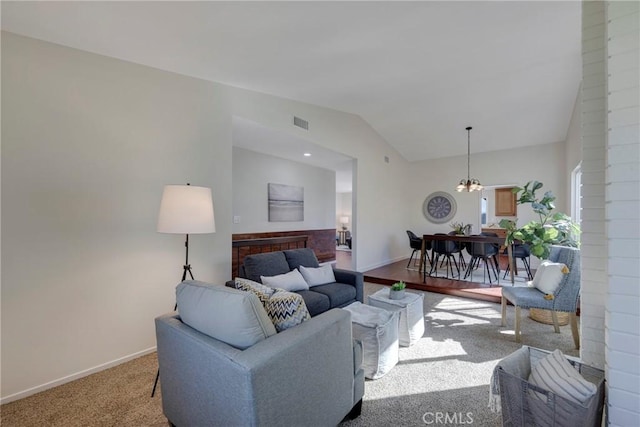 living room with lofted ceiling, visible vents, baseboards, and a notable chandelier