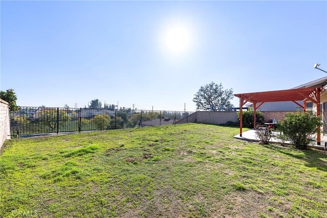 view of yard with a patio area, a fenced backyard, and a pergola