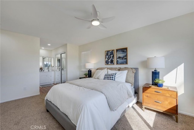 bedroom featuring carpet floors, recessed lighting, ensuite bathroom, ceiling fan, and baseboards