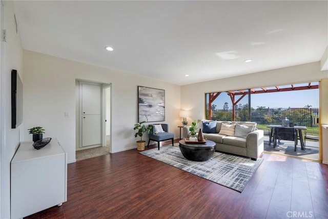 living room featuring baseboards, dark wood-type flooring, and recessed lighting