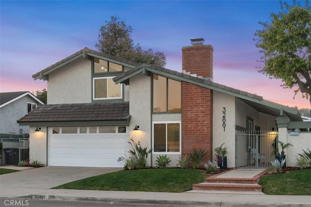 mid-century modern home with driveway, a chimney, fence, and stucco siding