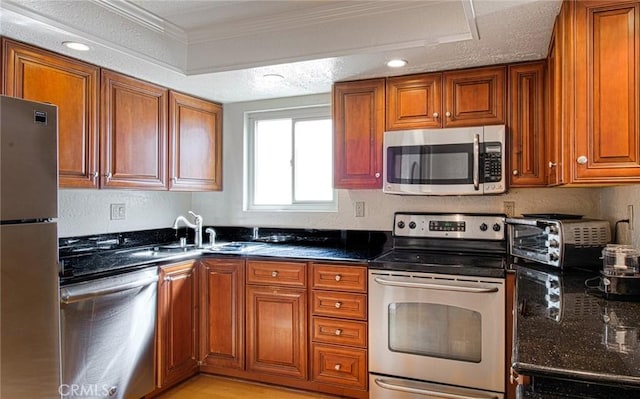 kitchen featuring stainless steel appliances, brown cabinets, and a toaster