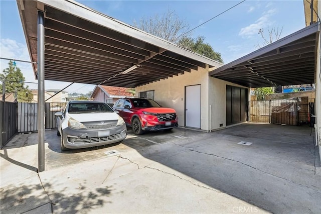 view of parking / parking lot featuring fence