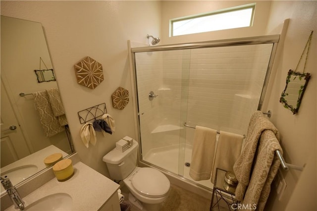 bathroom featuring a stall shower, vanity, and toilet