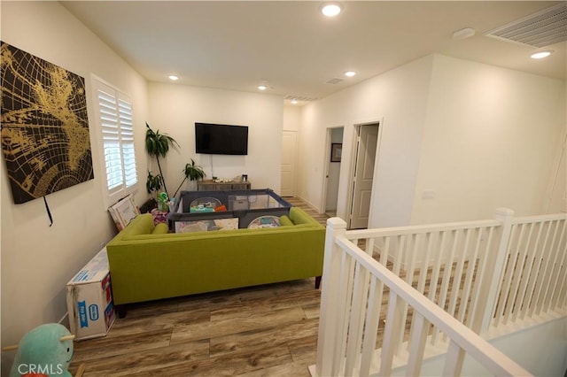 living room featuring visible vents, wood finished floors, and recessed lighting