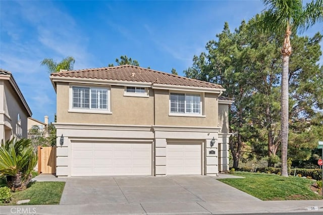 traditional-style house featuring a garage, concrete driveway, a tile roof, and stucco siding