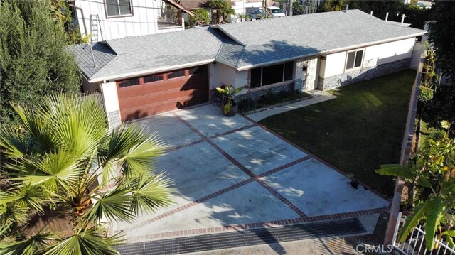 view of front of house with a shingled roof, driveway, and an attached garage