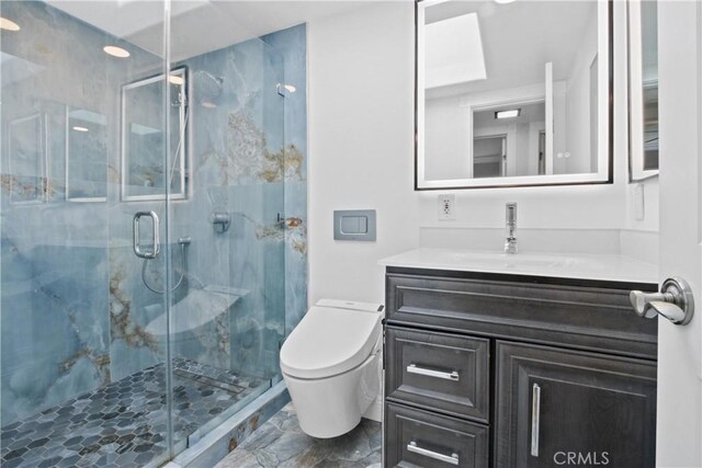 full bath with toilet, marble finish floor, a marble finish shower, and vanity