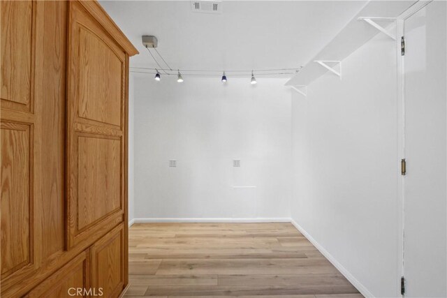 walk in closet with light wood-style flooring and visible vents