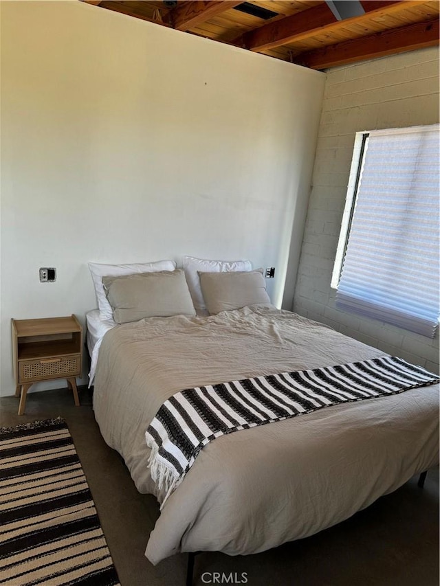 bedroom featuring beam ceiling and wood ceiling