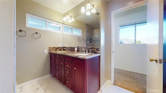 bathroom with marble finish floor, a sink, and double vanity