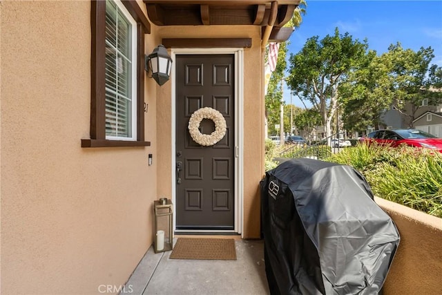 view of exterior entry featuring stucco siding