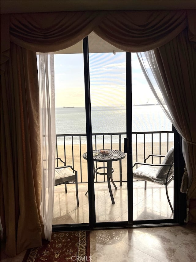 entryway featuring a water view and floor to ceiling windows