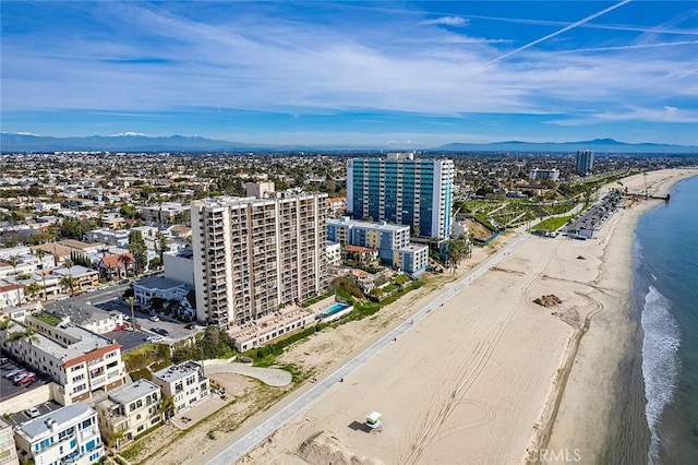 bird's eye view featuring a water view, a view of city, and a view of the beach