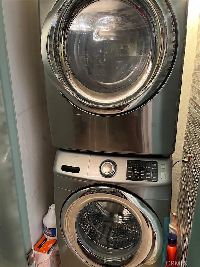 washroom with laundry area and stacked washer / dryer