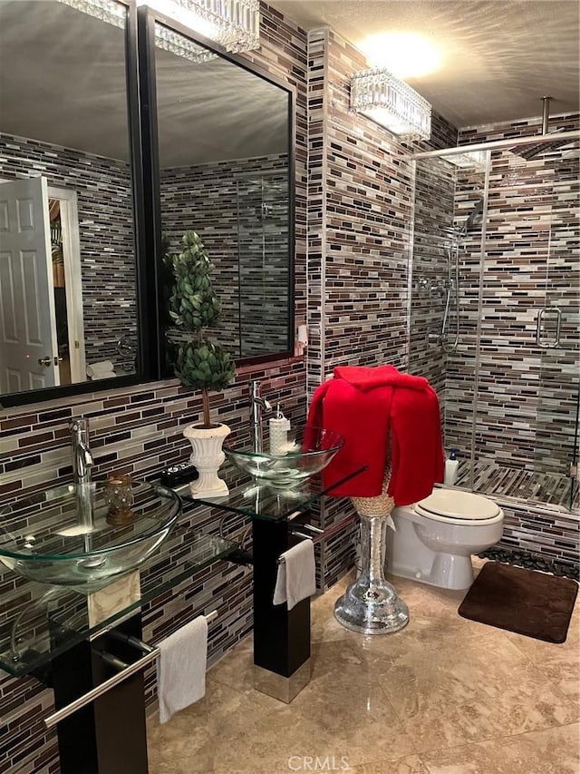 full bath with toilet, tasteful backsplash, and tile walls