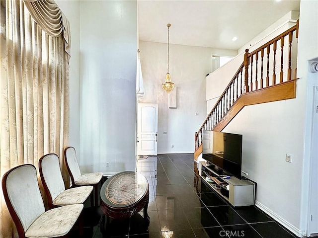 tiled dining space featuring a chandelier, stairway, baseboards, and a towering ceiling