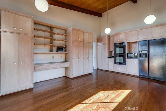 kitchen with hanging light fixtures, black appliances, and light brown cabinets