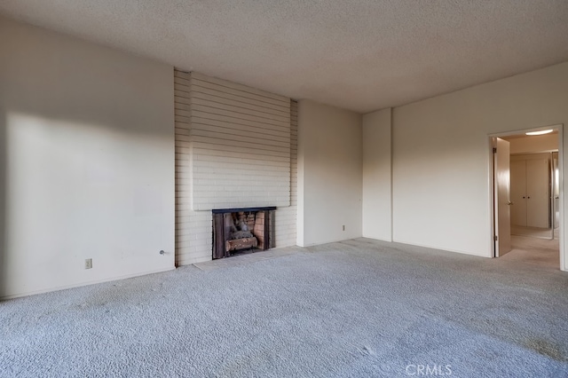 2229 Via Cerritos, Palos Verdes Estates, CA 90274 - unfurnished living room featuring a brick fireplace, carpet floors, and a textured ceiling