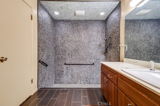 full bathroom with wood finish floors and vanity