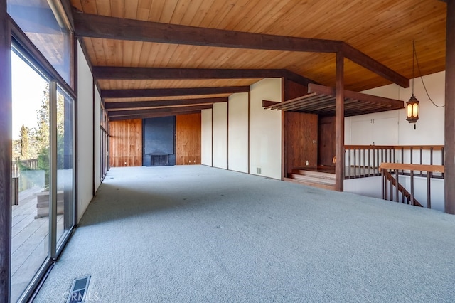 carpeted spare room featuring lofted ceiling with beams and wooden ceiling