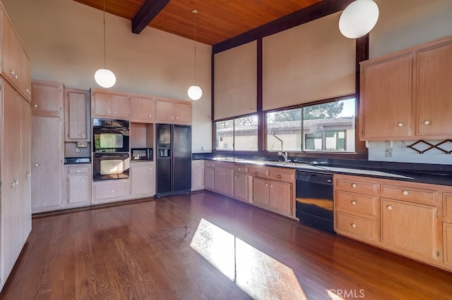 kitchen featuring light brown cabinets, black appliances, beamed ceiling, dark countertops, and decorative light fixtures