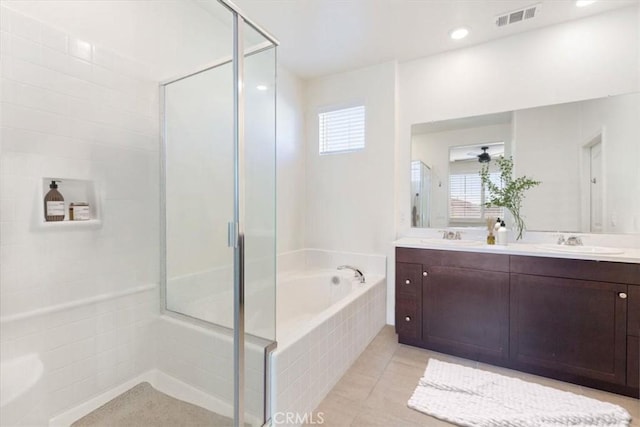 bathroom featuring double vanity, visible vents, a sink, a shower stall, and tile patterned floors