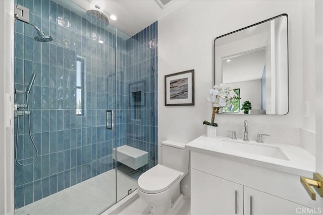 full bathroom with toilet, vanity, and a shower stall