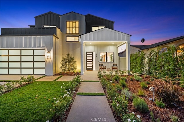 contemporary home featuring a front lawn and board and batten siding