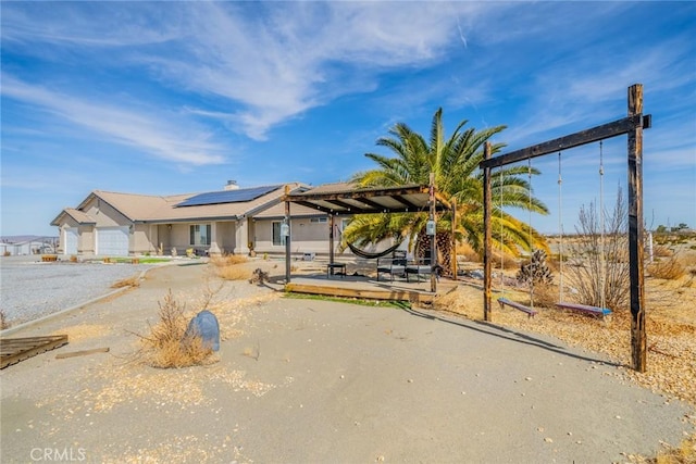 view of front of property featuring solar panels