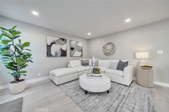 living room featuring recessed lighting, wood finished floors, and baseboards