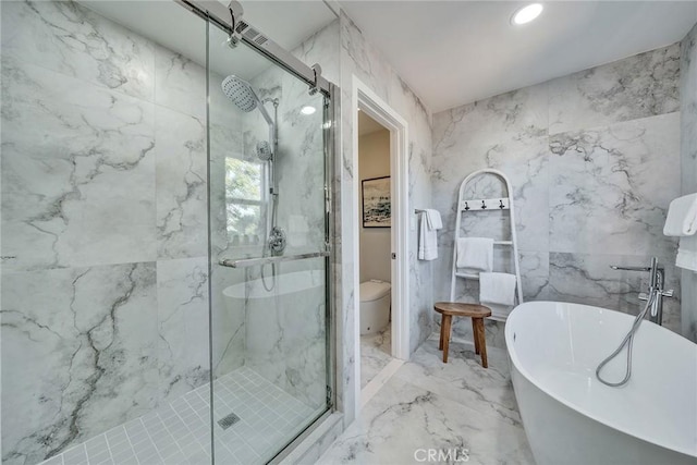 bathroom featuring marble finish floor, a marble finish shower, and stone wall