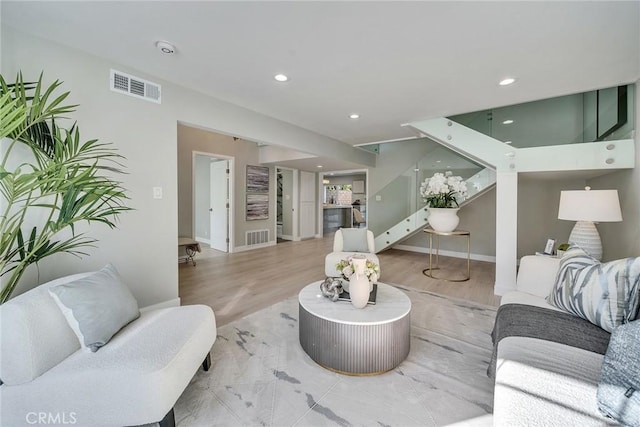 living room with baseboards, stairway, visible vents, and recessed lighting