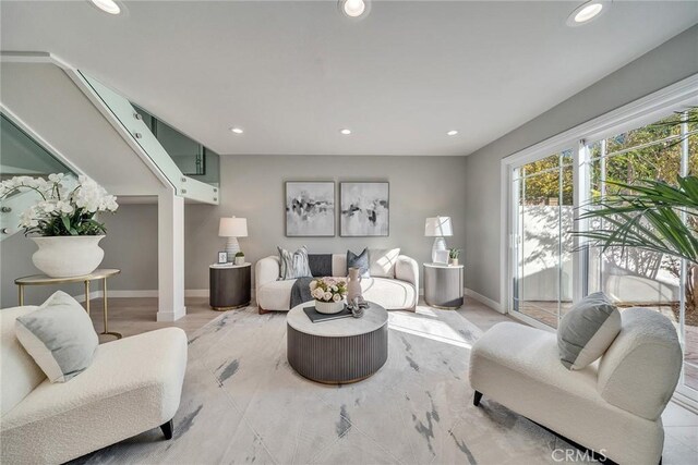 living area featuring baseboards and recessed lighting