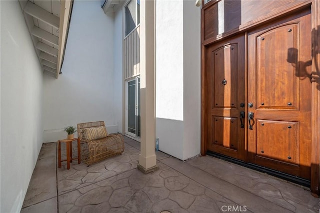 entrance to property featuring a patio area and stucco siding