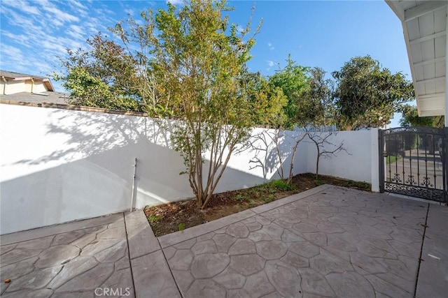 view of patio / terrace featuring a fenced backyard and a gate