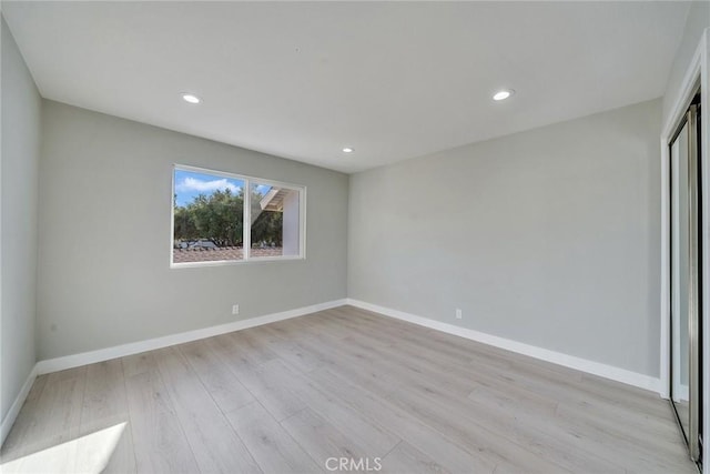 unfurnished bedroom featuring baseboards, recessed lighting, and light wood-style floors